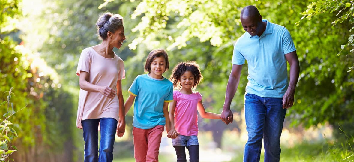 Family walking in nature on a sunny day