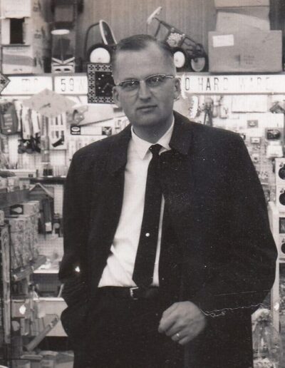 A Black and White Photograph of Leonard Astrup Standing in the Original Sterling Drug Store