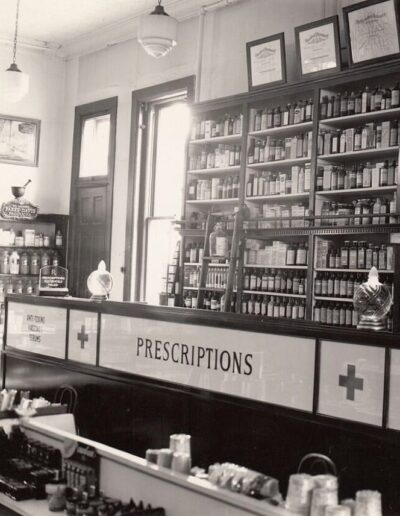 A Black and White Photo of the Prescriptions Sign and Counter at the Original Sterling Drug Store