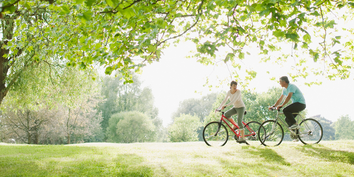 Two people enjoying the outdoors on bicycles.