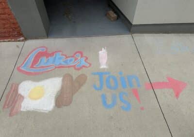 Chalk drawing of bacon and eggs and milkshake Luke's Join us!